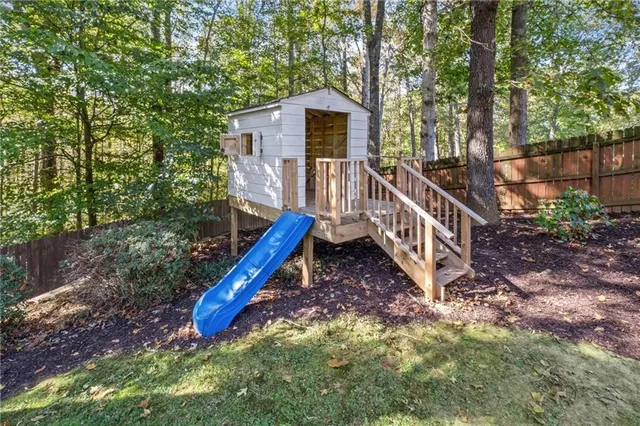 a view of a house with a yard from a deck