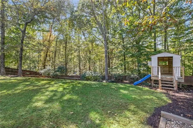 a view of a backyard with large trees