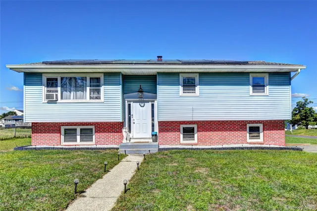 a front view of a house with a garden