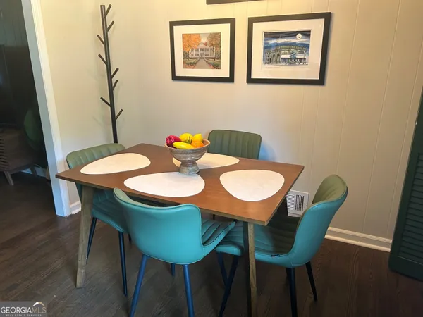 a view of a dining room with furniture and wooden floor