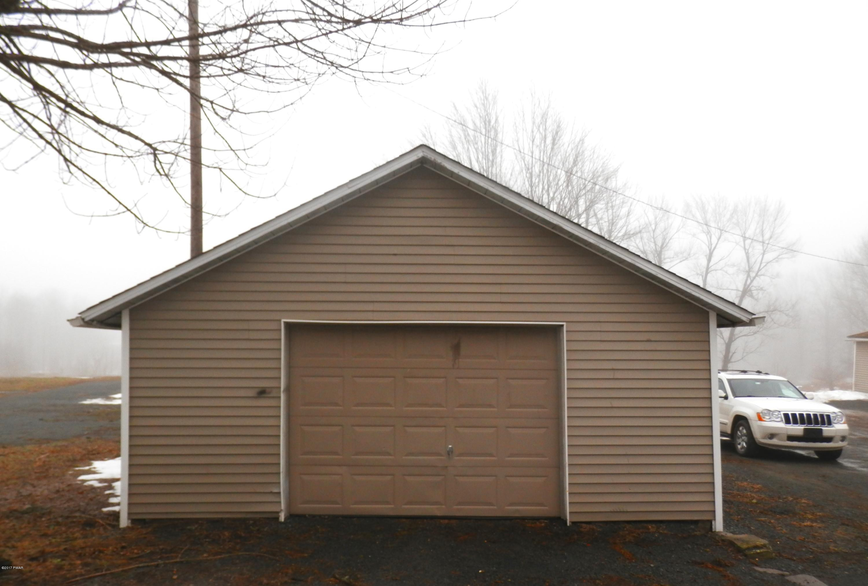 88 Hemlock Road Lake Ariel, PA 18436 - Photo 4 of 22 a view of garage yard and front view of a house