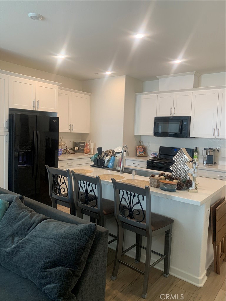 985 West Clover Avenue Rialto, CA 92376 - Photo 5 of 11 a kitchen with a refrigerator and a stove top oven
