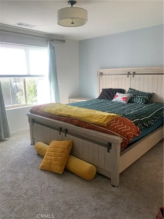 a bed sitting in a room next to a window
