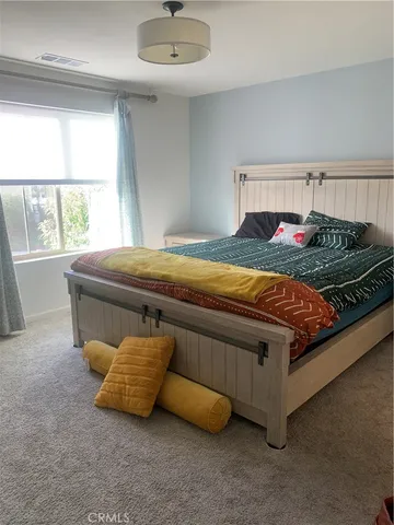 a bed sitting in a room next to a window