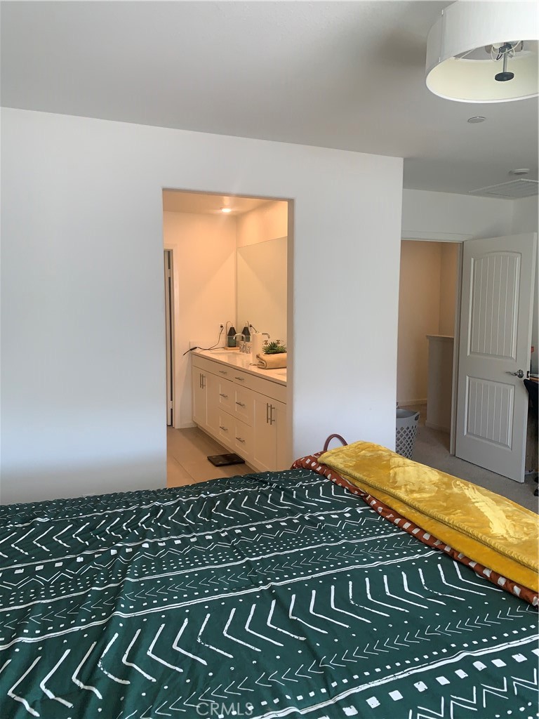 985 West Clover Avenue Rialto, CA 92376 - Photo 7 of 11 a bedroom with a bed and a window