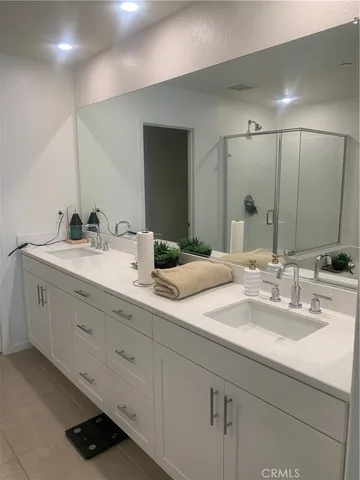 a bathroom with double sink and a mirror