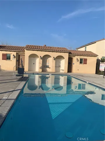 a view of a white house with a big yard