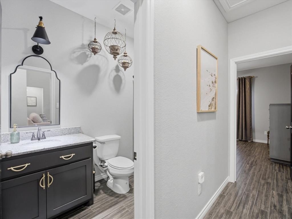 117 Ranchview Court Bowie, TX 76230 - Photo 21 of 40 a bathroom with a toilet a sink and mirror