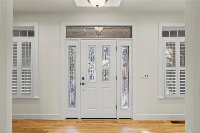 a bedroom with a large bed and a large window