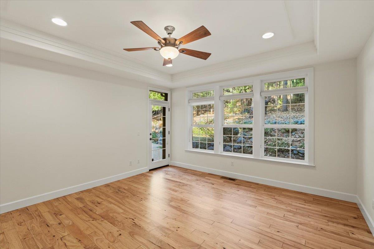 14622 Banner Lava Cap Road Nevada City, CA 95959 - Photo 29 of 66 an empty room with wooden floor and windows
