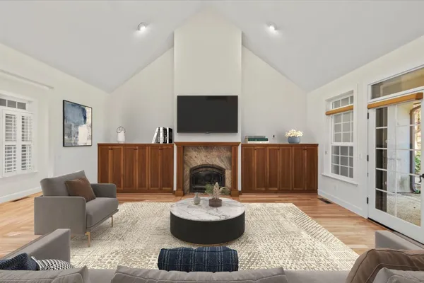 a living room with furniture a fireplace and a flat screen tv