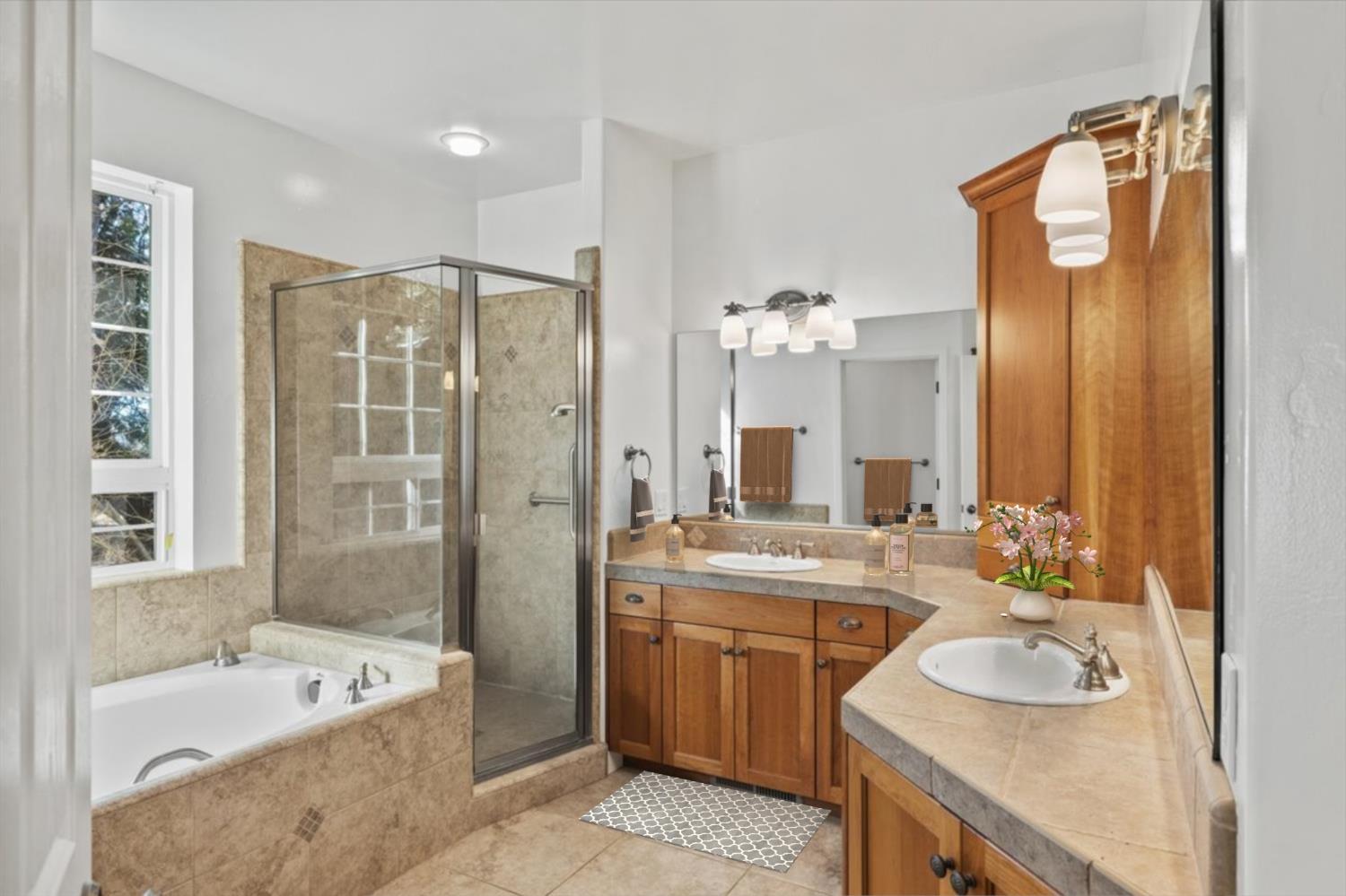 14622 Banner Lava Cap Road Nevada City, CA 95959 - Photo 32 of 66 a bathroom with a sink double vanity granite tub shower and a mirror