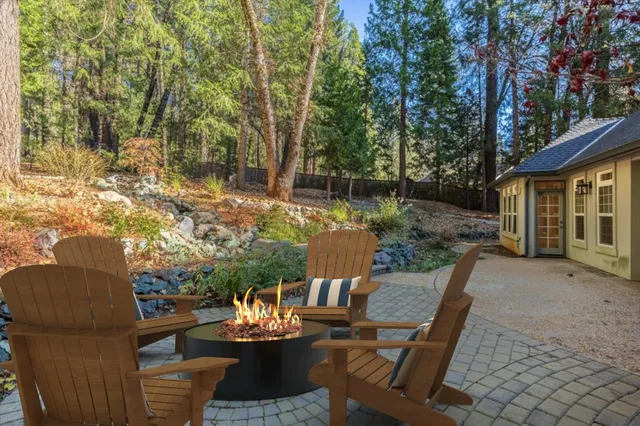 a view of a patio with couches table and chairs and potted plants