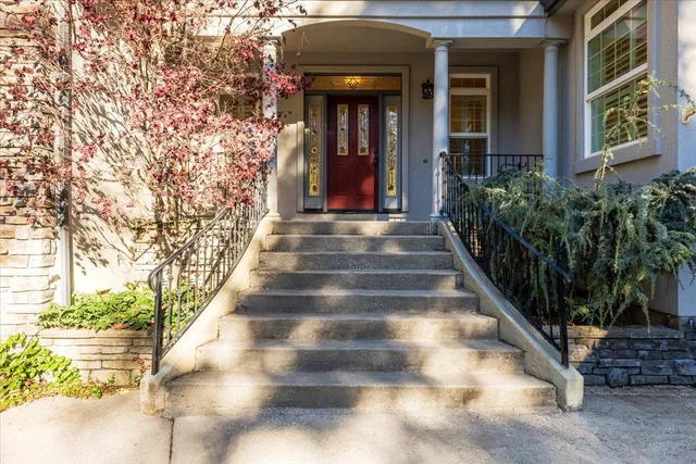 wooden floor in an empty room with a fireplace and a window