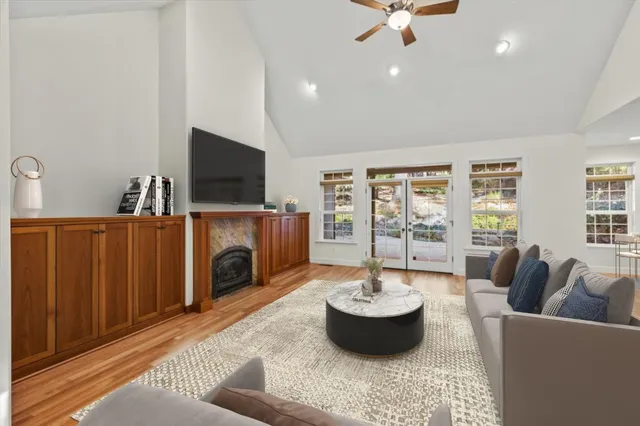 a living room with furniture and a wooden floor