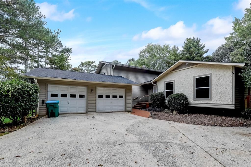 4129 Valley Brook Road Snellville, GA 30039 - Photo 1 of 1 a house with trees in the background
