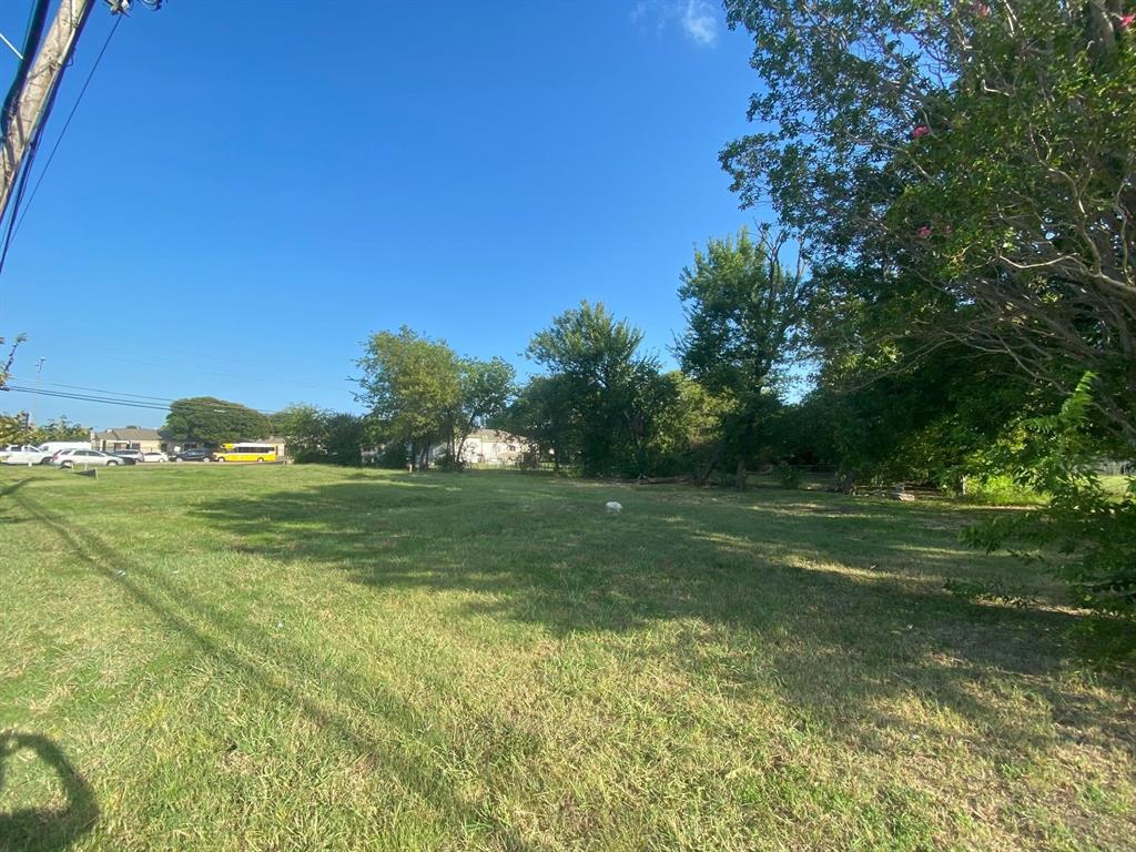 451 North Jim Miller Road Dallas, TX 75217 - Photo 2 of 6 a view of a field with grass and trees