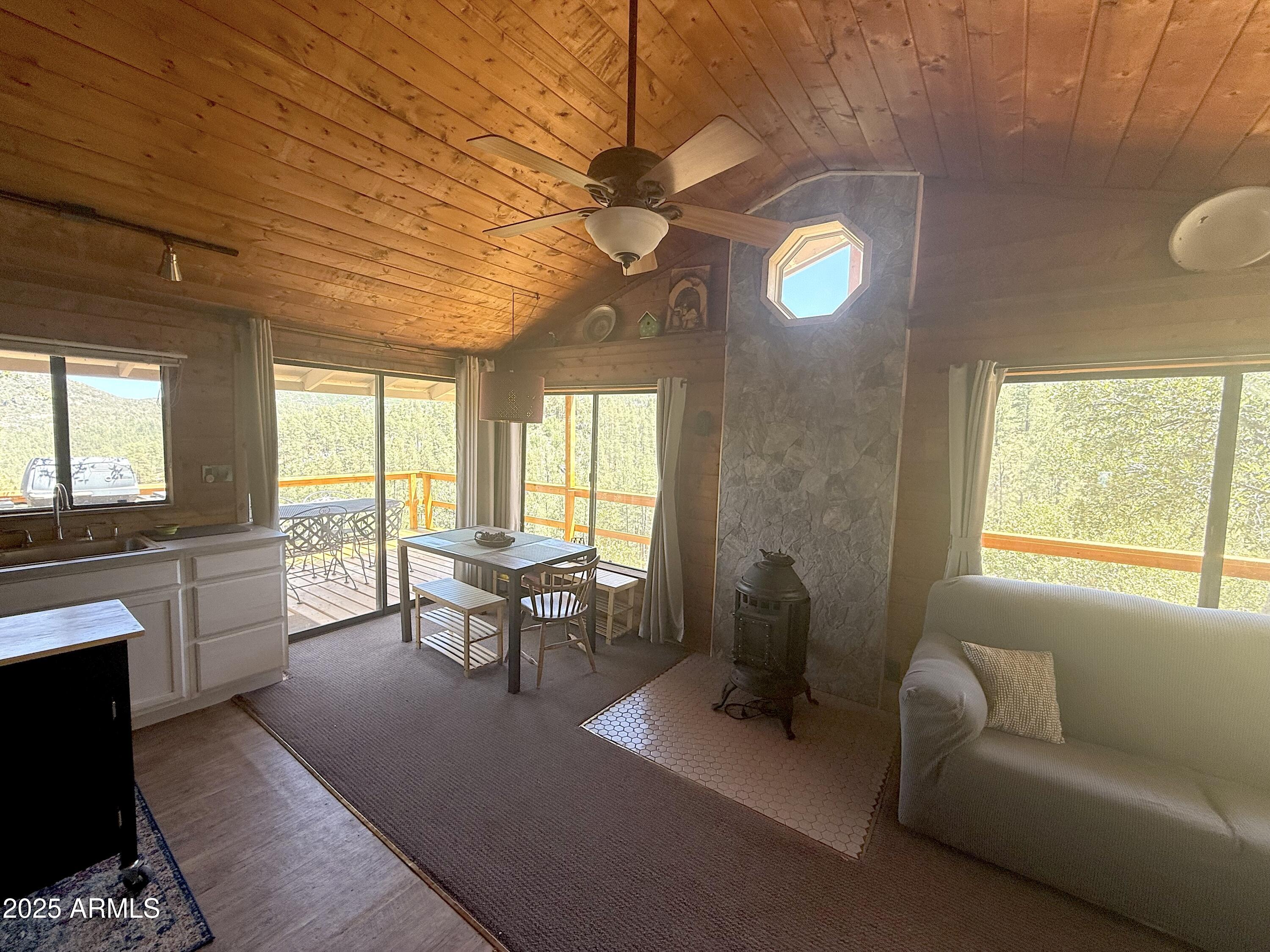23659 Sunny South Road Crown King, AZ 86343 - Photo 15 of 29 a living room with furniture a fireplace and a large window