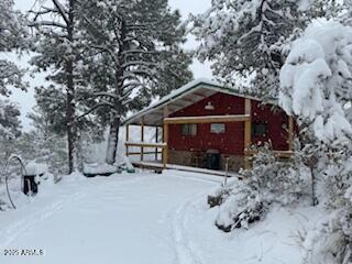 23659 Sunny South Road Crown King, AZ 86343 - Photo 2 of 29 a view of a house with a yard covered in snow