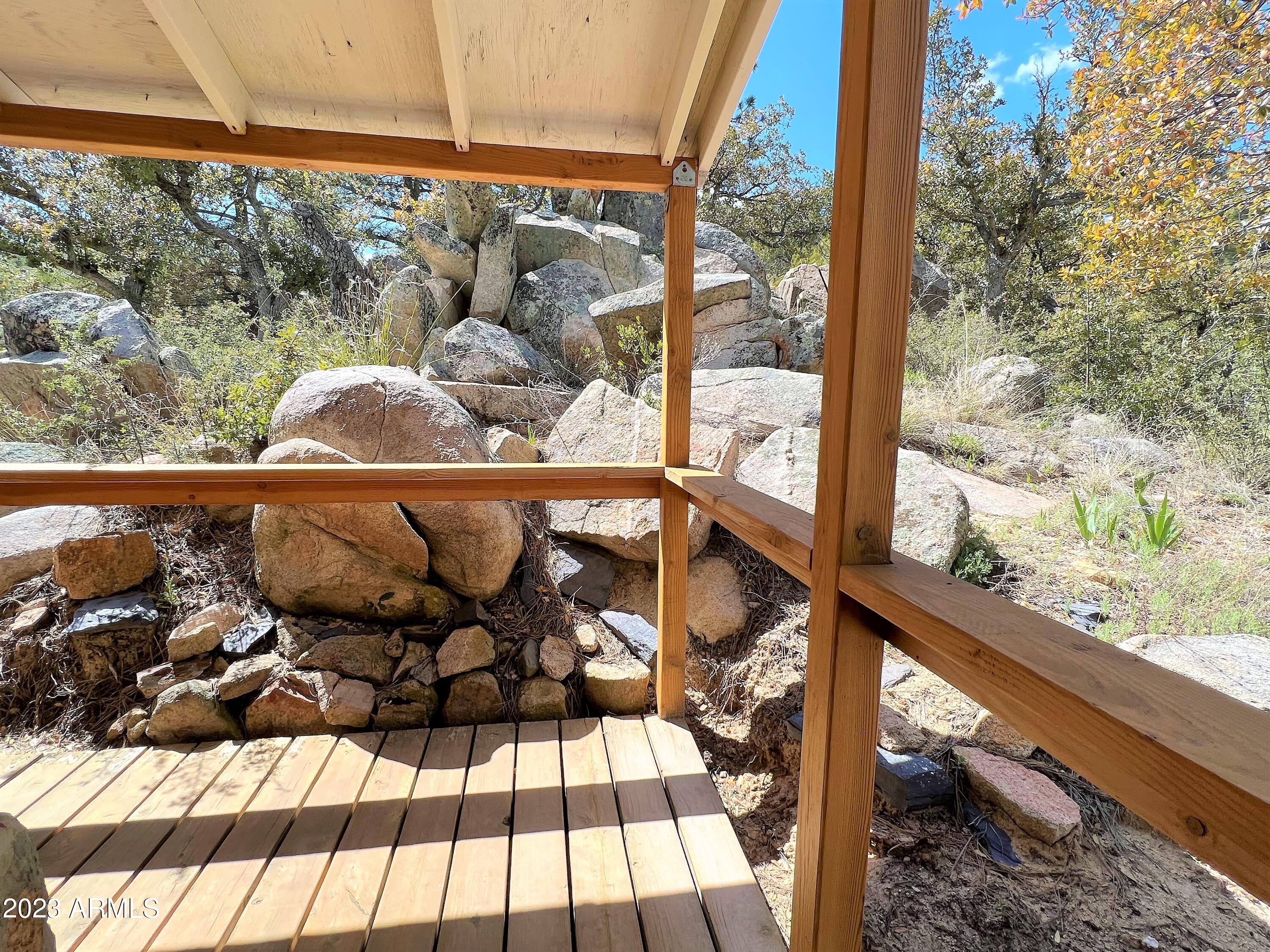 23659 Sunny South Road Crown King, AZ 86343 - Photo 25 of 29 a view of a balcony with chairs and wooden floor