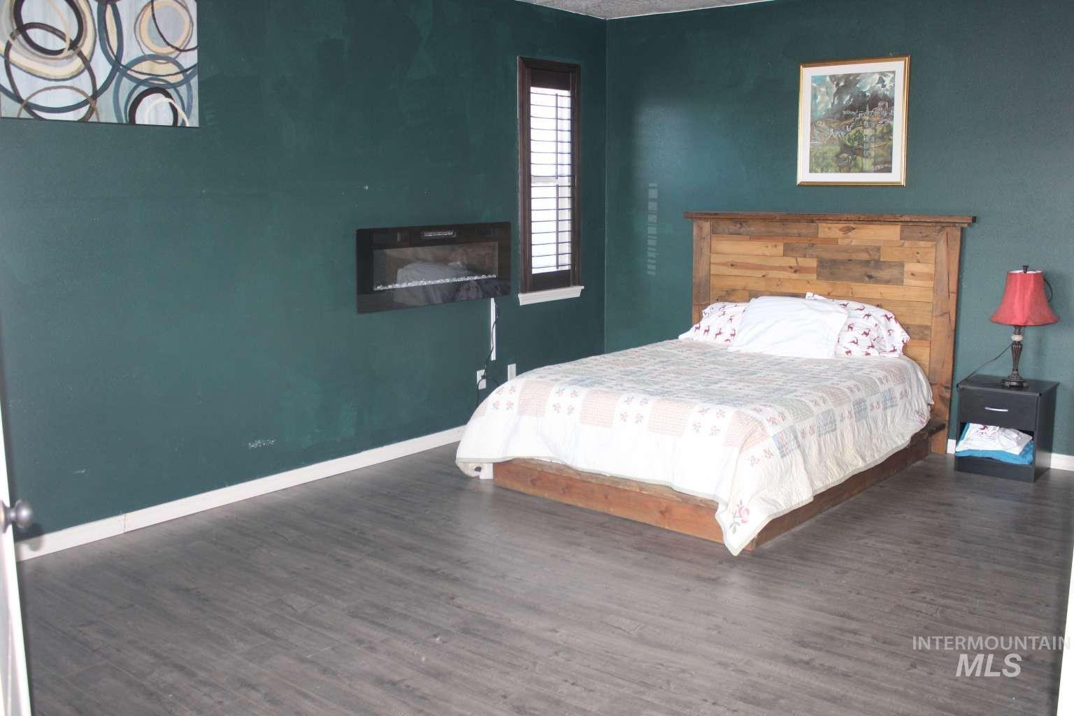1422 River View Lane Buhl, ID 83316 - Photo 31 of 43 Bedroom with dark wood finished floors and a fireplace