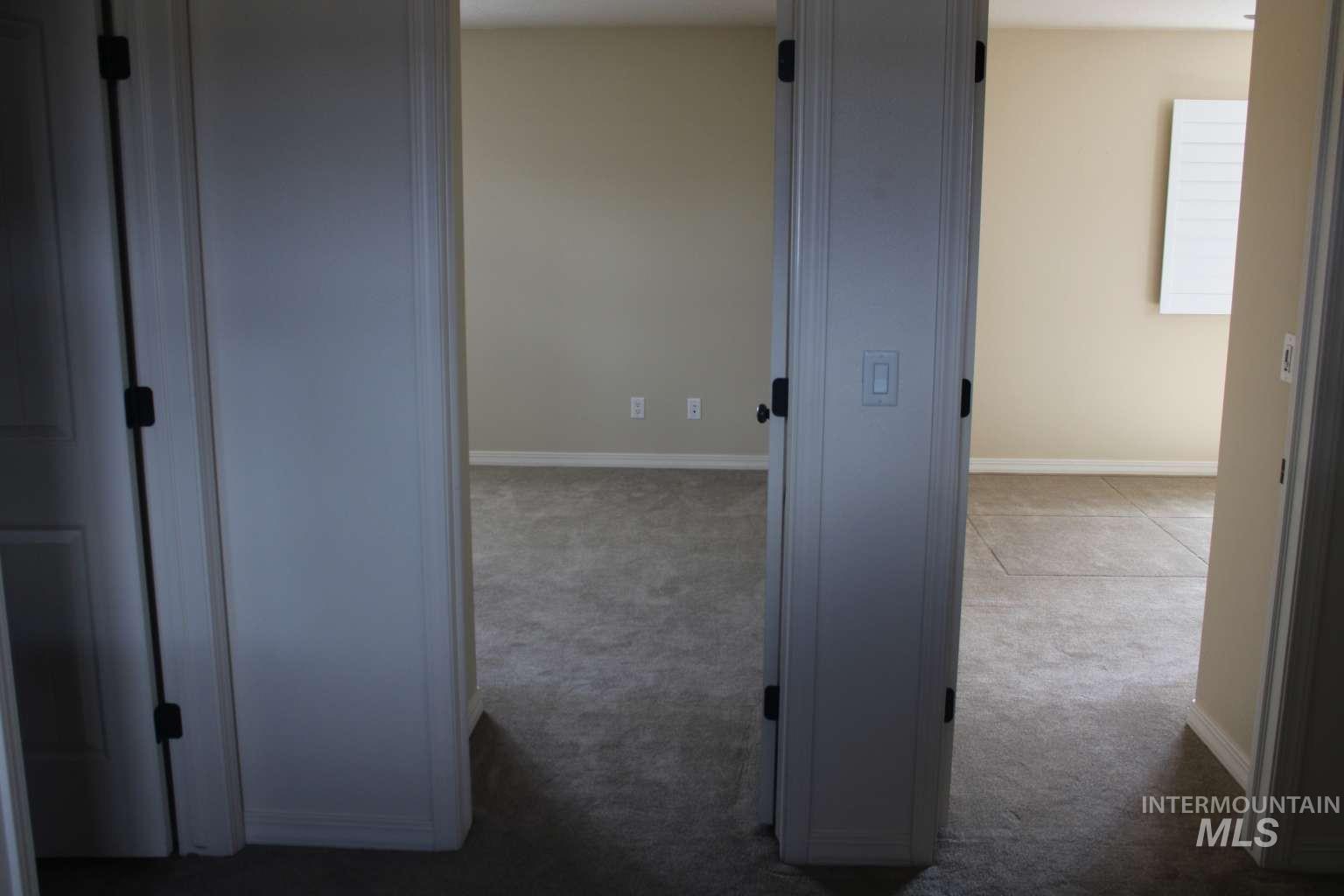 1422 River View Lane Buhl, ID 83316 - Photo 34 of 43 Corridor featuring baseboards and dark colored carpet