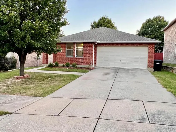 a backyard of a house with yard and potted plants
