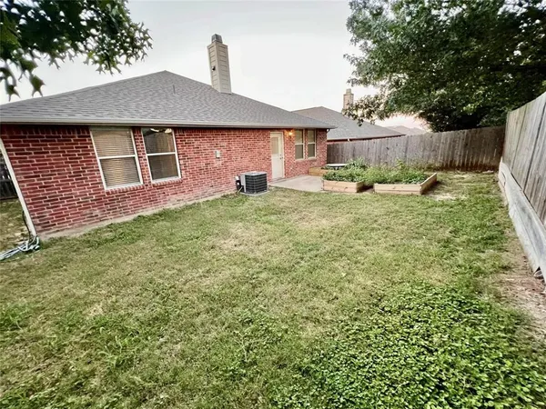 a backyard of a house with table and chairs