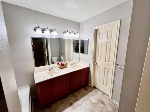 a bathroom with a sink vanity and mirror