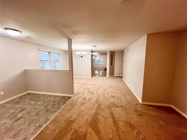 a view of a big room with wooden floor and cabinet
