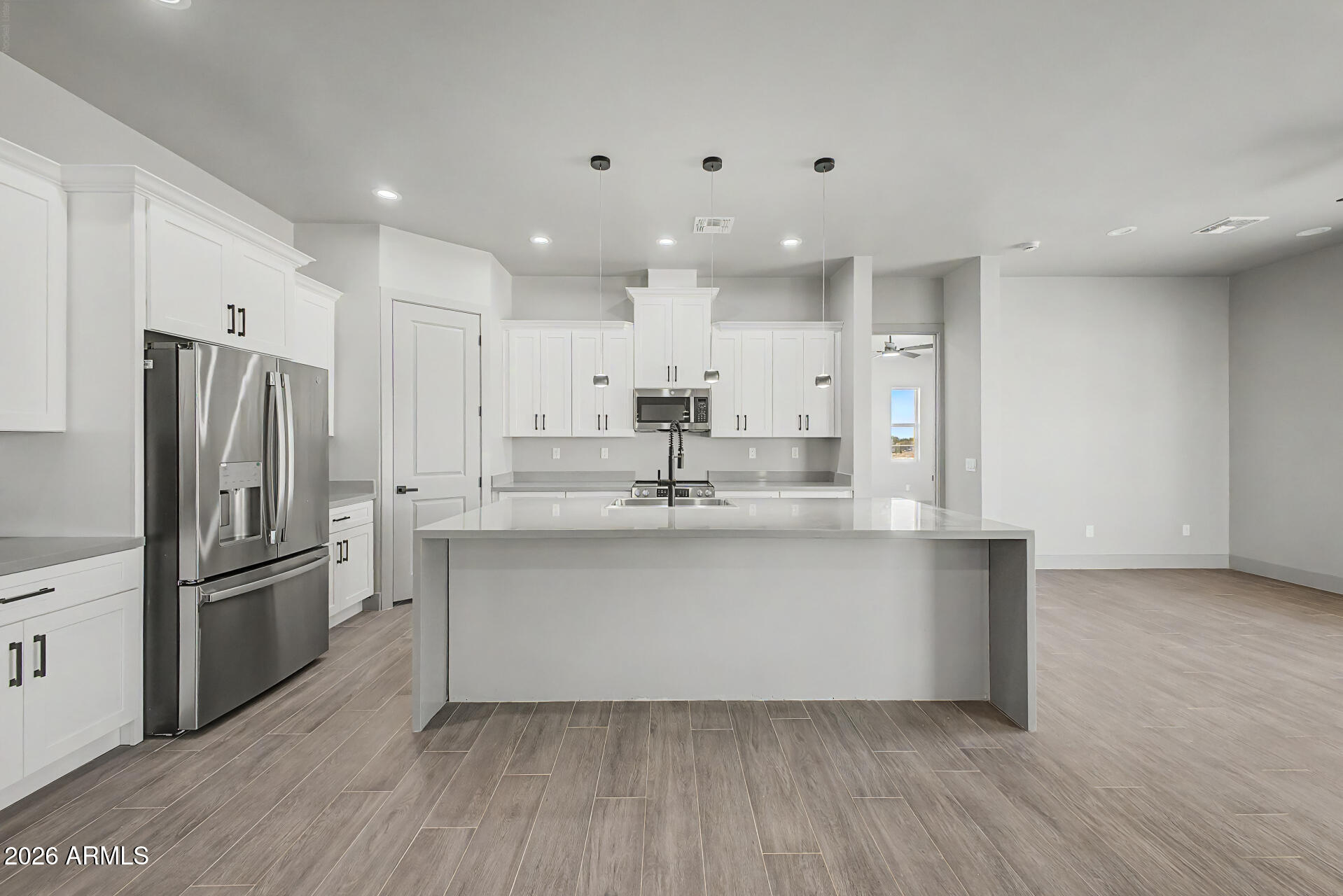 40461 West Robles Road Stanfield, AZ 85172 - Photo 25 of 54 a kitchen with kitchen island a sink stainless steel appliances and cabinets