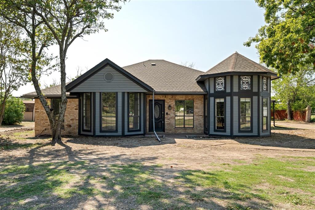 770 Meadowbrook Drive Lucas, TX 75098 - Photo 1 of 1 Back of property with fence, brick siding, and roof with shingles