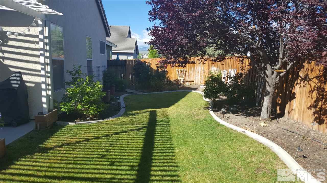 10281 Wolf Ridge Way Reno, NV 89521 - Photo 18 of 22 a view of a house with a yard