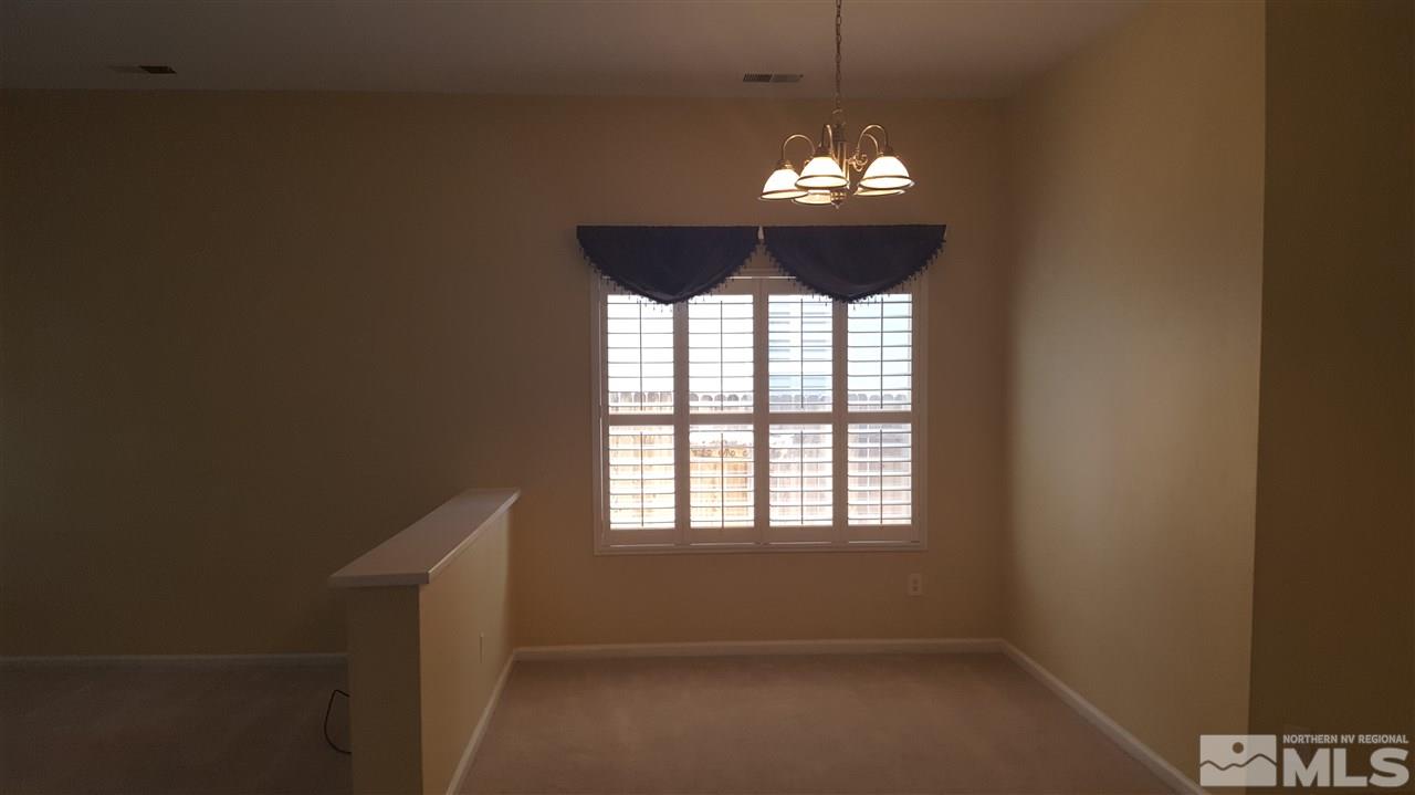 10281 Wolf Ridge Way Reno, NV 89521 - Photo 6 of 22 a chandelier in a room with a chandelier