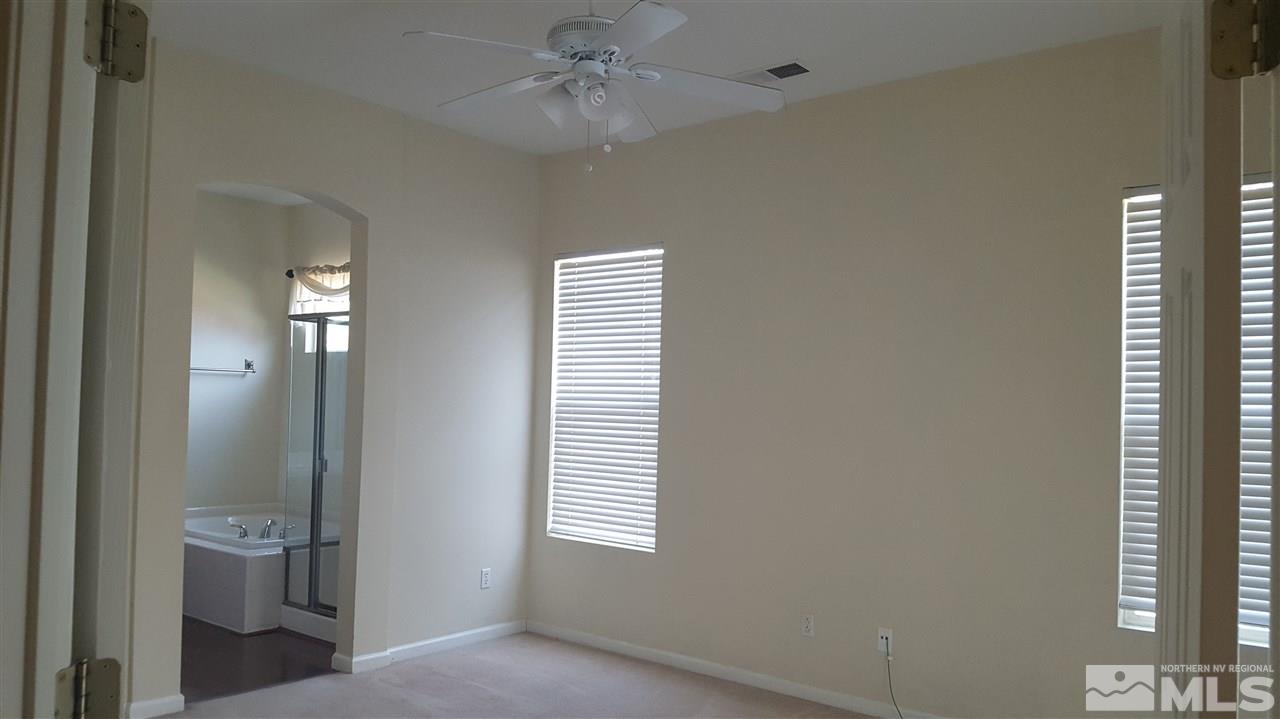10281 Wolf Ridge Way Reno, NV 89521 - Photo 8 of 22 a view of empty room with windows and fan