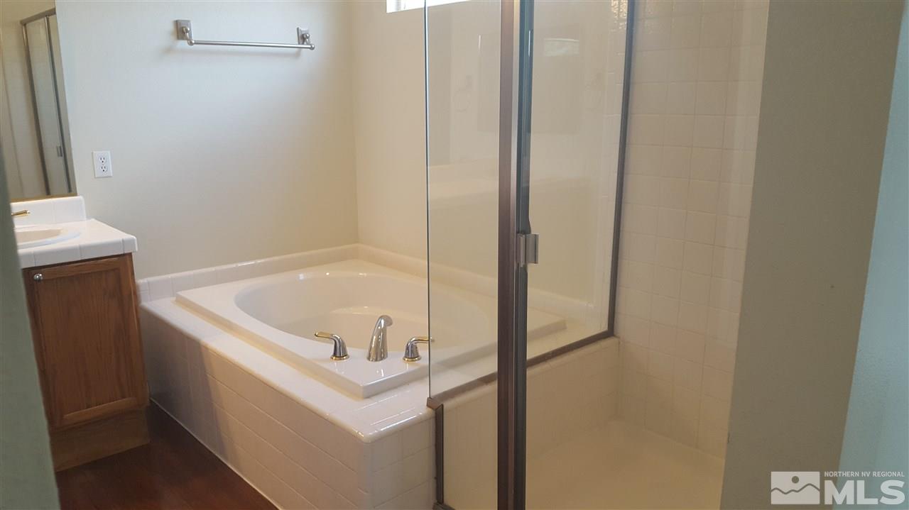 10281 Wolf Ridge Way Reno, NV 89521 - Photo 10 of 22 a white bath tub sitting next to a white sink