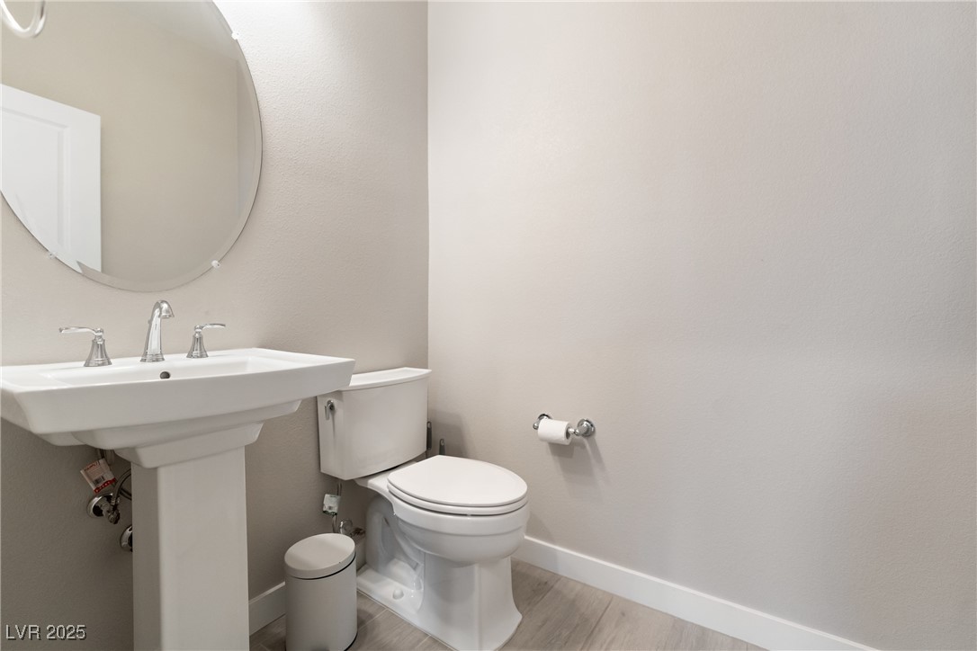 12 Papavero Court Henderson, NV 89011 - Photo 13 of 17 Bathroom with baseboards and light wood-type flooring