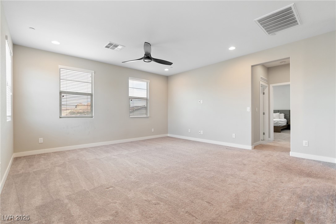 12 Papavero Court Henderson, NV 89011 - Photo 5 of 17 Spare room with light colored carpet, recessed lighting, and a ceiling fan