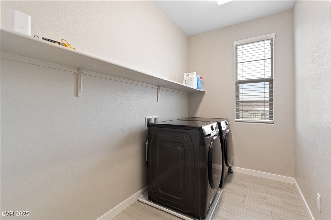 12 Papavero Court Henderson, NV 89011 - Photo 9 of 17 Laundry room featuring light wood-type flooring, separate washer and dryer, and a skylight