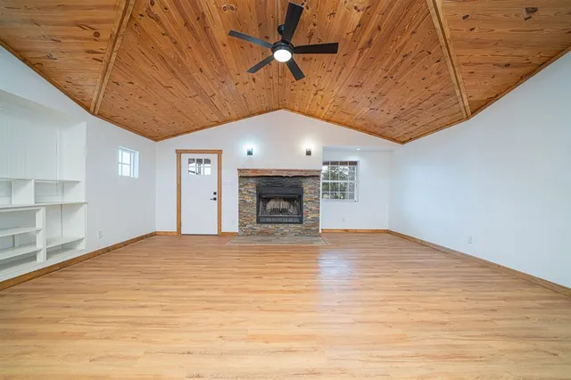 wooden floor in an empty room with a fireplace