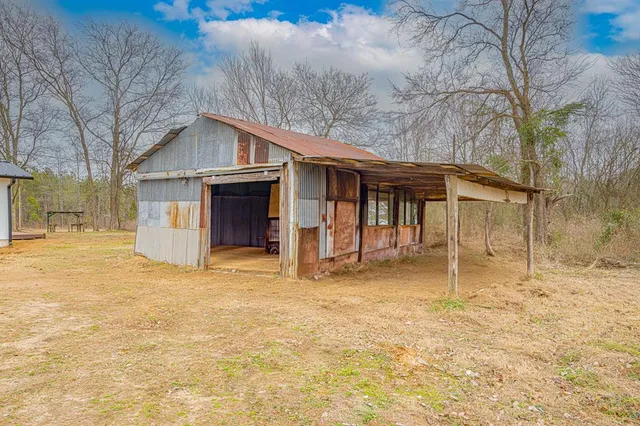 a view of house with a yard and garage