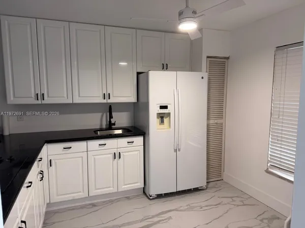 a white refrigerator freezer sitting inside of a kitchen