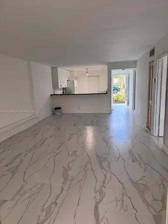 a view of a kitchen with a sink and a window