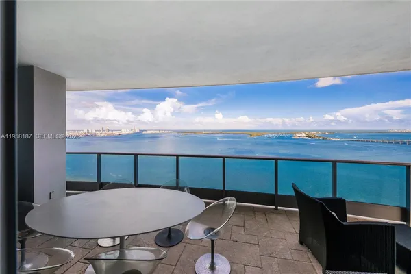 a view of a balcony with chair and table
