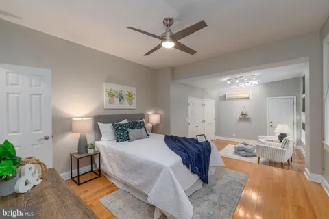 a spacious bedroom with a large bed and a chandelier