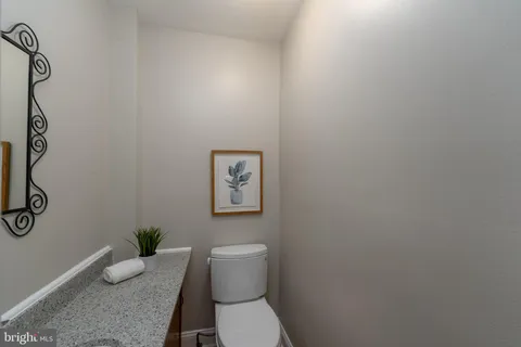 a bathroom with a toilet and a shower curtain