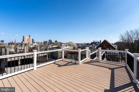 a view of a balcony with wooden floor and city view