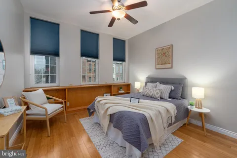 a bedroom with a bed and a chandelier