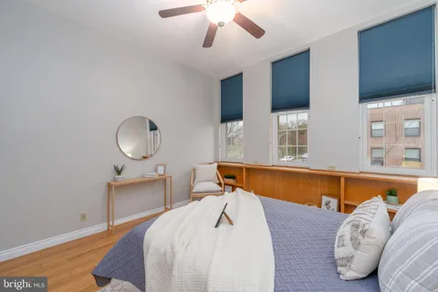 a bedroom with a bed and wooden floor