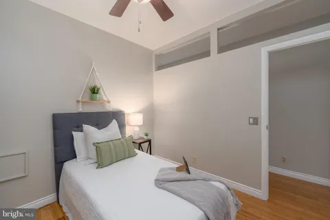 a bedroom with a bed and a potted plant